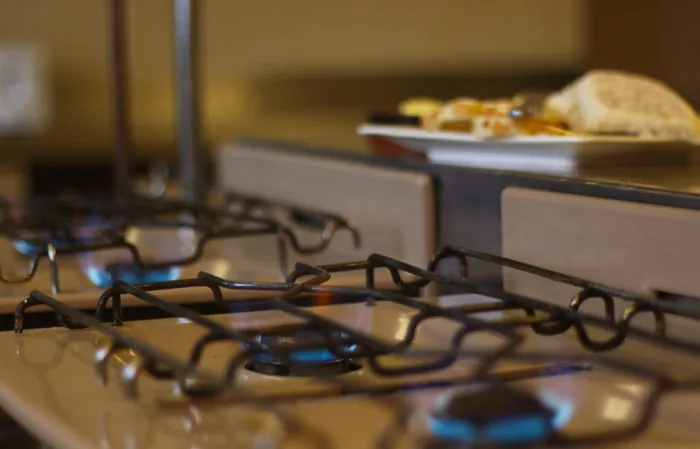 A pan sizzling on the gas hob in our self-catering kitchen